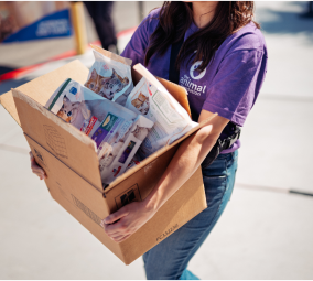 Helper carrying a box with donations