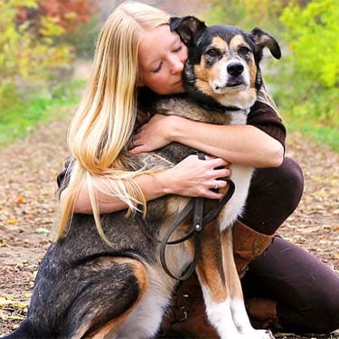 Owner hugging her dog