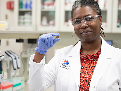 a scientist holding Hill's Pet dog food in her hand